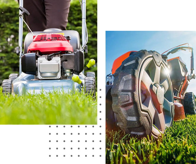 A person using a red gas-powered lawn mower on a sunny day with a close-up of the mower's wheel on the grass, performing residential landscaping.